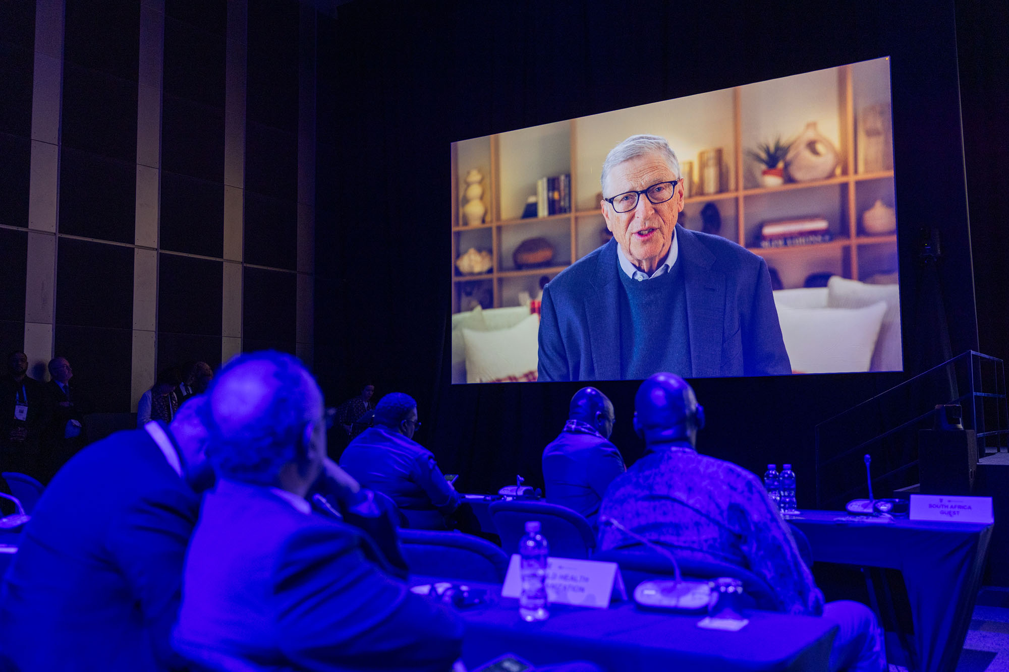 Audiences watch as Bill Gates, Chair and Board Member, Gates Foundation, delivers a video message at the Global Fund’s Eighth Replenishment Summit in Johannesburg, South Africa, on 21 November 2025.