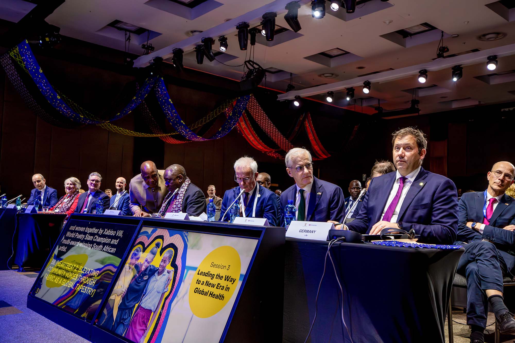Front row from right to left: Lars Klingbeil, Vice Chancellor and Minister of Finance of Germany; Jonas Gahr Støre, Prime Minister of Norway; Peter Sands, Global Fund Executive Director; Cyril Ramaphosa, President of South Africa; Dr. Aaron Motsoaledi, Minister of Health of South Africa; Sir Keir Starmer MP, Prime Minister of the United Kingdom; Lady Roslyn Morauta, Global Fund Board Chair; and Micheál Martin, Taoiseach, Prime Minister of the government of Ireland.